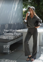 @sienna stands outdoors wearing an olive-green half-zip sweatshirt and matching mid-rise active pants with dark slide sandals, holding a coffee cup and a black bag. Text: Your Wardrobe's Missing Piece. All Day Active Midrise Pants $120* T&Cs apply- Shop Now