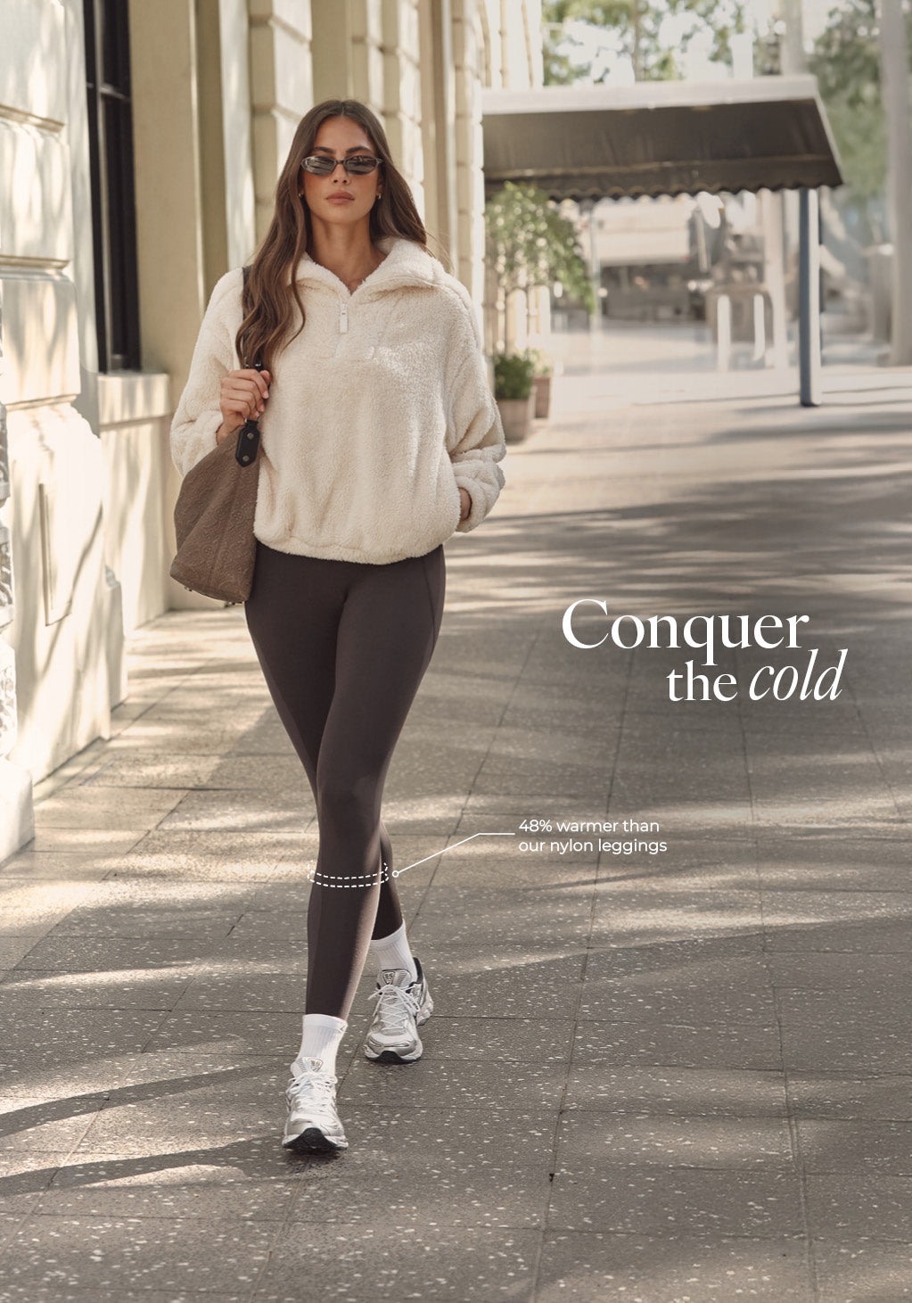 Conquer the cold, 48% warmer than our nylon leggings. Model wearing white jumper and brown leggings