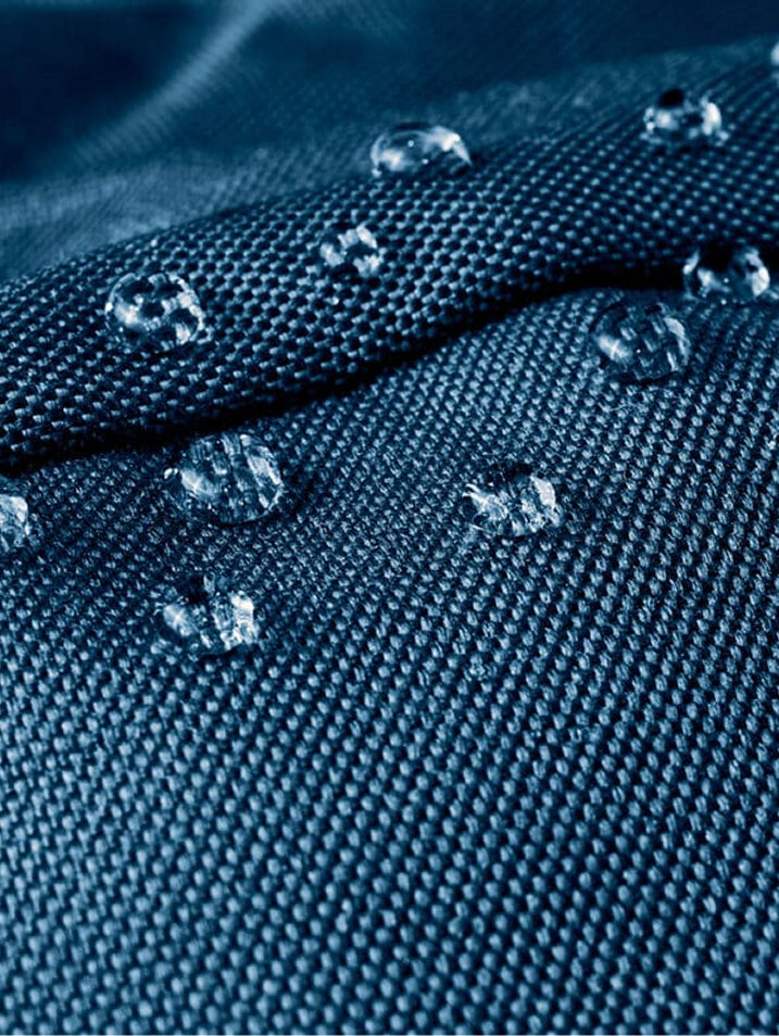 Close-up of water droplets beading on moisture-wicking performance fabric.