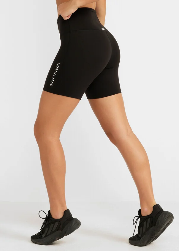 woman from waist down wearing black mid length bike shorts