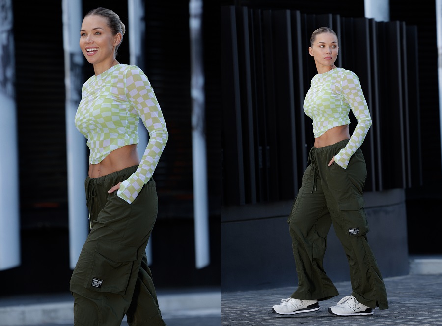 woman wearing army green cargo pants and a tight cropped long sleeve top