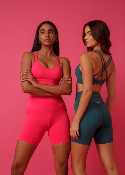 two woman wearing different coloured matching bike short and sports bra sets
