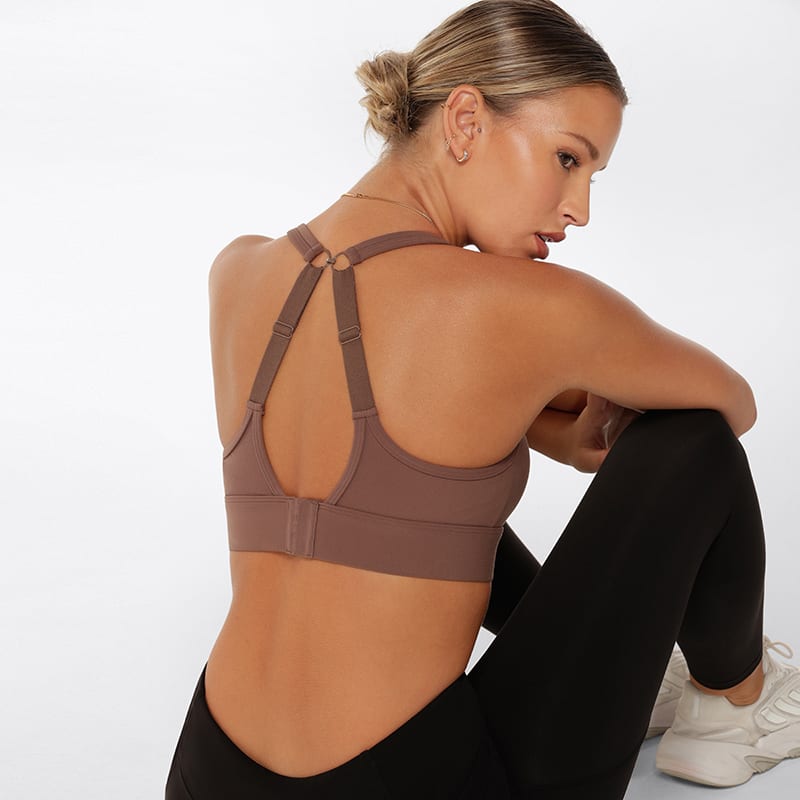 Back shot of a model wearing a chocolate-coloured Compress & Compact Sports Bra