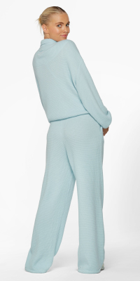woman wearing matching blue tracksuit pants and sweater