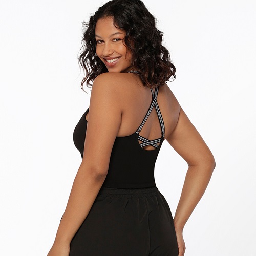 brunette woman wearing black shelf bra tank with strappy back detailing