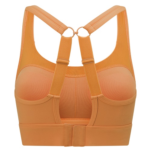Model wearing a beige toffee coloured sports bra with moulded padding